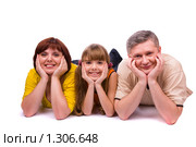 Счастливая семья. Папа, мама и дочка лежат на полу. Стоковое фото, фотограф Ирина Карлова / Фотобанк Лори