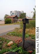 Колонка и старый дом на фоне современного строения (2010 год). Стоковое фото, фотограф Надежда Коновалова / Фотобанк Лори