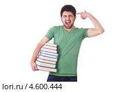 Студент с книгами подмышкой приставил палец к голове. Стоковое фото, фотограф Elnur / Фотобанк Лори