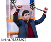 Новый "Прометей". Мужчина прикован к пачке ЕВРО. Коллаж. Стоковое фото, фотограф Валерий Тырин / Фотобанк Лори