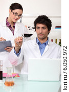 Man and woman testing wine in laboratory. Стоковое фото, фотограф Phovoir Images / Фотобанк Лори