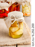 Glass jar of pickled mushrooms on wooden table. Autumn dish. Стоковое фото, агентство BE&W Photo / Фотобанк Лори