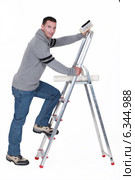 Man putting up wallpaper. Стоковое фото, фотограф Phovoir Images / Фотобанк Лори