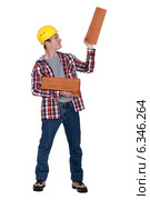 Roofer holding stack of tiles. Стоковое фото, фотограф Phovoir Images / Фотобанк Лори