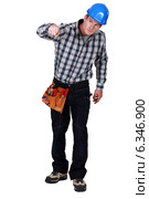 Curious tradesman pressing a button. Стоковое фото, фотограф Phovoir Images / Фотобанк Лори