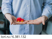 Man holds in his hand cars. Стоковое фото, агентство Ingram Publishing / Фотобанк Лори