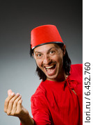 Man in red dress wearing fez hat. Стоковое фото, фотограф Elnur / Фотобанк Лори