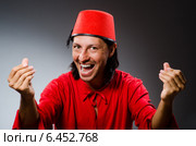 Man in red dress wearing fez hat. Стоковое фото, фотограф Elnur / Фотобанк Лори