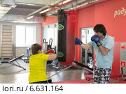 Отец с сыном боксируют в спортзале (2014 год). Редакционное фото, фотограф Володина Ольга / Фотобанк Лори