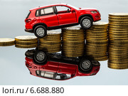 rising car costs. car on coins. Стоковое фото, фотограф Erwin Wodicka / Фотобанк Лори