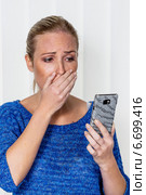 woman is shocked by sms. Стоковое фото, фотограф Erwin Wodicka / Фотобанк Лори