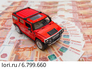 Красный автомобиль на фоне из пятитысячных купюр. Стоковое фото, фотограф Джигарян Дмитрий / Фотобанк Лори