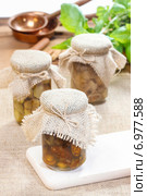 Glass jar of pickled mushrooms on jute table cloth. Autumn dish. Стоковое фото, агентство BE&W Photo / Фотобанк Лори