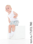 Unhappy baby boy sits on cube. Стоковое фото, фотограф Мельников Дмитрий / Фотобанк Лори