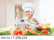 cook works with ladle at kitchen. Стоковое фото, фотограф Яков Филимонов / Фотобанк Лори