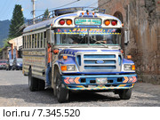 Chicken bus (Camioneta) colloquial name a colorful modified and decorated bus that transports goods and people between communities in Honduras and Guatemala.Guatemala, Antigua, typical colorful and decorated bus. Редакционное фото, агентство BE&W Photo / Фотобанк Лори