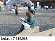 Московский фестиваль "Книги России" 2015 на Красной площади, молодой человек зачитался книгой. Редакционное фото, фотограф Дмитрий Неумоин / Фотобанк Лори