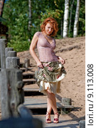 Red-haired adult woman in dune near the . Стоковое фото, фотограф Roberts Ratuts / PantherMedia / Фотобанк Лори