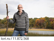 Mature man holding a stick. Стоковое фото, фотограф Shannon Fagan / PantherMedia / Фотобанк Лори