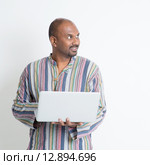 Mature casual Indian man using notebook. Стоковое фото, фотограф Wong Sze Fei / PantherMedia / Фотобанк Лори