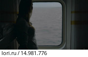 Girl opening blind in cabin to look at the sea. Стоковое видео, видеограф Данил Руденко / Фотобанк Лори