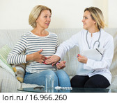 Young therapeutist and senior female with pain in belly. Стоковое фото, фотограф Яков Филимонов / Фотобанк Лори