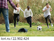 girl and three boys playing football in spring park and smiling. Стоковое фото, фотограф Яков Филимонов / Фотобанк Лори
