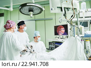 surgeons team hands during laparoscopic abdominal operation in child surgery. Стоковое фото, фотограф Дмитрий Калиновский / Фотобанк Лори
