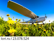Самолет Cessna-172S стоит на стоянке возле поля одуванчиков (2016 год). Редакционное фото, фотограф Oleg Ivanchenko / Фотобанк Лори
