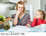 woman working from home, little daughter asking for attention. Стоковое фото, фотограф Яков Филимонов / Фотобанк Лори