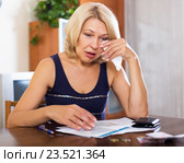Sad woman sits at the table. Стоковое фото, фотограф Яков Филимонов / Фотобанк Лори