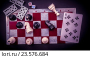 Various board games and figurines over checkers board. Стоковое видео, видеограф Роман Гадицкий / Фотобанк Лори