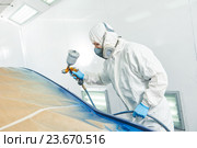 repairman painter in chamber painting automobile car bumper. Стоковое фото, фотограф Дмитрий Калиновский / Фотобанк Лори