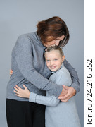 Grandmother kissing and hugging her granddaughter. Стоковое фото, фотограф Olesya Tseytlin / Фотобанк Лори