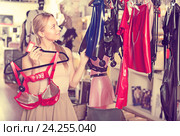 Woman selecting sexy underwear in sex shop. Стоковое фото, фотограф Яков Филимонов / Фотобанк Лори
