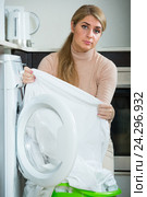 Adult woman with musty linen after laundry at home. Стоковое фото, фотограф Яков Филимонов / Фотобанк Лори