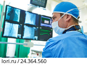 Interventional cardiology. Male surgeon doctor at operation. Стоковое фото, фотограф Дмитрий Калиновский / Фотобанк Лори