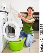 Tired woman doing laundry at home. Стоковое фото, фотограф Яков Филимонов / Фотобанк Лори
