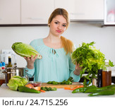 Young housewife tired of cooking vegetables in domestic kitchen. Стоковое фото, фотограф Яков Филимонов / Фотобанк Лори