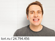 Portrait of smiling young man with dental braces. Стоковое фото, фотограф Сергей Новиков / Фотобанк Лори