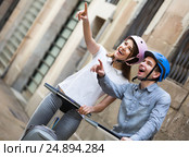Laughing couple going sightseeing by segways. Стоковое фото, фотограф Яков Филимонов / Фотобанк Лори