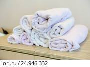 Stack of bath towels on light wooden background. Стоковое фото, фотограф Георгий Ильин / Фотобанк Лори