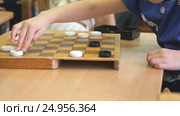 Children play checkers at a kindergarten. Close-up. Стоковое видео, видеограф worker / Фотобанк Лори