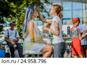 Девушке красят волосы в радужные цвета на фестивале «Das Fest - 2016» на ВДНХ. Редакционное фото, фотограф Владимир Князев / Фотобанк Лори