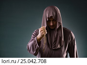 Monk in religious concept on gray background. Стоковое фото, фотограф Elnur / Фотобанк Лори
