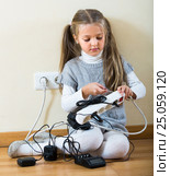 Little girl playing with sockets at home. Стоковое фото, фотограф Яков Филимонов / Фотобанк Лори