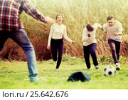girl and three boys playing football in spring park and smiling. Стоковое фото, фотограф Яков Филимонов / Фотобанк Лори