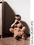 Lonely sad boy crying in corner, holding toy bear. Стоковое фото, фотограф Pavel Biryukov / Фотобанк Лори