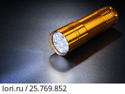 Luminous flashlight on dark surface. Стоковое фото, фотограф Alexander / Фотобанк Лори