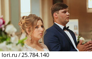 Newlyweds are baptized in the church at their wedding. Стоковое видео, видеограф Mikhail Davidovich / Фотобанк Лори